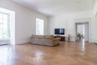 Bright interior room remodeling reference with modern TV wall and clean finishes.