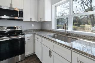 Bright kitchen remodeling reference with counters, appliances, and large windows.