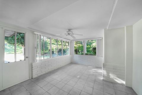 Sunroom addition reference with large windows, tiled floor, and natural light.